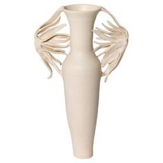 a white vase with large wings on it's body and back side, sitting in front of a white background