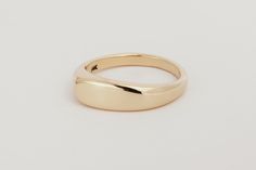 a gold wedding ring on a white background