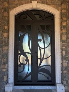 an ornate glass door on a stone building