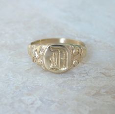 This ring is an Edwardian inspired signet ring that is designed and hand engraved just for you. This ring was originally hand carved in wax, and engraving is done completely by hand, which aims to stay true to the vintage vibe of the design. 8 karat gold is a lower grade of gold used often in vintage items. As it tends to darken slightly over time, this adds to the overall effect. Material: 8 Karat Gold (please message for 14, 18 or 22K gold, which are also available.) Custom engraving is availa Rings Signet, Vintage Style Rings, Gold Signet Ring, Small Rings, Vintage Vibe, Stay True, 22k Gold, Hand Engraving, Vintage Engagement Rings