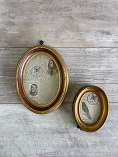 an old fashioned photo frame with birds on it sitting next to a small round box