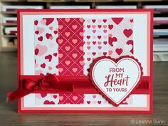 a valentine's day card with a heart and ribbon attached to the front, sitting on a table