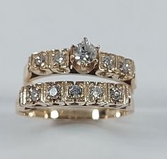 two gold wedding rings with diamonds on each one and an engagement ring in the other