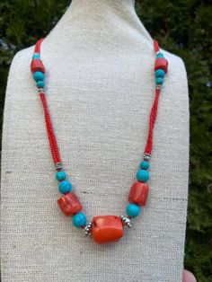 Dive into elegance with our Blue Turquoise Pendant Necklace featuring vibrant Red Coral accents. This handcrafted masterpiece blends serene turquoise with energetic coral, creating a unique and stylish statement piece that effortlessly elevates any look. The centerpiece, a mesmerizing blue turquoise pendant, enchants with its serene hues and intricate patterns, evoking a sense of tranquility and sophistication. The dynamic presence of vibrant red coral accents adds a bold and distinctive dimension, infusing the necklace with a burst of energy and charisma. Adjustable Turquoise Necklace With Colorful Beads, Vibrant Adjustable Necklace For Gift, Vibrant Round Bead Jewelry Gift, Handmade Red Turquoise Necklace For Jewelry Making, Vibrant Adjustable Beaded Necklaces As Gift, Vibrant Adjustable Beaded Necklaces For Gifts, Vibrant Handmade Beaded Necklace For Gift, Vibrant Handmade Jewelry For Gifts, Turquoise Necklace With Colorful Beads Gift