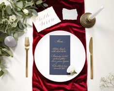 a table setting with place settings, napkins and silverware on top of it