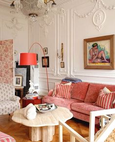 a living room filled with furniture and a chandelier