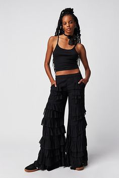 Make a statement for the frill of it in these need-now novelty pants. **Fit:** Mid-rise, billowy tiered design **Features:** Pull-on design, tiered ruffle trimming, raw-edge details, back smocked waistband feature **Why We | Rock And Frill Pants by Free People in Black, Size: XS Frill Pants, Ruffle Pants Outfit, Bohemian Pants, We Rock, Festival Pants, Ruffle Pants, Boho Pants, Fantasy Fashion, Model Pictures