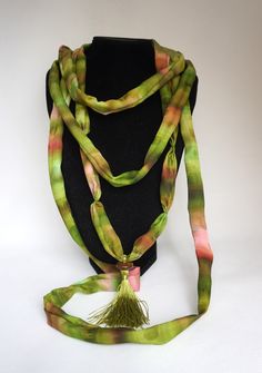 Long necklace in chartreuse green and pink hand-painted silk This necklace is made with silk scraps from my scarves. It is made of 3 different necklaces, to wear together or separately The two largest can be worn as a cuff bracelet I added on the smallest necklace, a chartreuse green pompom topped with a wooden bead, which gives it a chic bohemian side * 100% silk * Necklace length: 194 cm * Width: 3 cm * High quality French paintings *Heat fixed to preserve colors * Made in Lyon * green, chartreuse green, spring green, brown  Wedding Anniversary, Birthdays Packaging : Ready for gifting - carefully packaged in natural tones tissue paper and business card Sending : by tracked letter for France and by registered parcel for international destinations Packaging : carefully packaged in tissue p Handmade Bohemian Green Silk Scarf, Handmade Green Bohemian Silk Scarf, Green Bohemian Silk Scarf For Gift, Green Bohemian Silk Scarf As Gift, Bohemian Green Silk Scarf As Gift, French Paintings, Silk Necklace, Chartreuse Green, Small Necklace