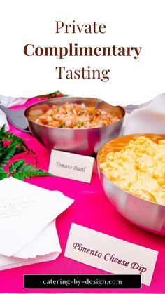 a pink table topped with two bowls filled with food and place cards next to each other