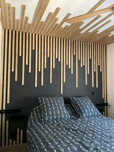 a bed sitting under a wooden slatted ceiling