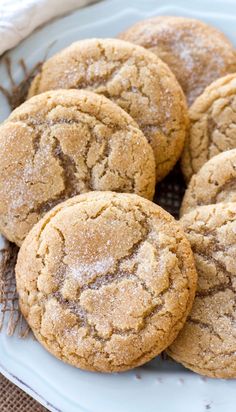 a white plate topped with cookies covered in powdered sugar