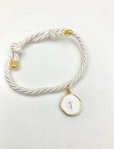 a white rope bracelet with an initial charm