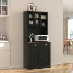 a kitchen area with a microwave, cabinet and counter top in black wood grain finish