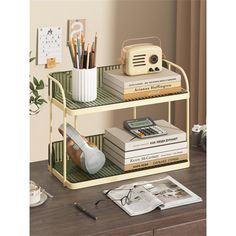 two tiered shelf with books, pencils and other items sitting on top of it