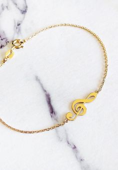 "14K 9K Gold Music Note Bracelet, Treble Clef Charm Bracelet, Dainty Music Note Bracelet, Solid Gold Bracelet, Musician Gift, Music Lover Gift, Christmas Gift, FREE EXPRESS SHIPPING Beautiful and delicate bracelet with a treble clef/note charm made in 14K or 9K solid gold. \"Music gives a soul to the universe, wings to the mind, flight to the imagination and life to everything.\" -- Plato Whisper...I love Music! -------------------------------------------------- D E T A I L S 14K Solid Gold or 9 Music-themed Band Jewelry As Gift, Music-themed Band Jewelry Gift, Music-themed Bracelet Jewelry Gift, Music Note Bracelet, Solid Gold Bracelet, Musician Gifts, Gold Designs, Bracelet Dainty, Treble Clef