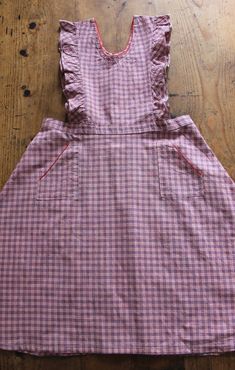 FRENCH VINTAGE 50's, lovely pinafore dress / apron dress, pink and blue checkered cotton fabric, red trim edges, wide open sleeves, two patch pockets, buttoned down the waist ( glass buttons ). Estimated size 9 years : Length 32,3" New old stock ( washed once ) In case of multiple purchases, if you want an accurate shipping estimation, please contact me ; I do always refund overcharged shipping from 1 Euro overpaid ! Thank you for your visit Retro Cotton Plaid Dress For Picnic, Retro Cotton Plaid Dress, Retro Plaid Cotton Dress, Cotton Gingham Plaid Dress With Ruffles, Gingham Plaid Cotton Dress With Ruffles, Retro Gingham Plaid Cotton Dress, Red Cotton Plaid Dress For Picnic, Cotton Plaid Ruffled Dress For Picnic, Vintage Cotton Plaid Dress