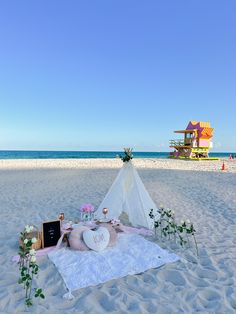 a table set up on the beach for a wedding