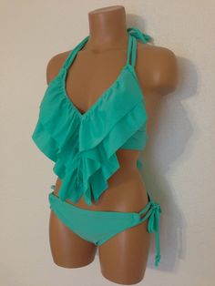 "Ruffle two piece swimsuit.Fully lined. Ruffle swimsuit top & adjustable tie side bikini scrunch bottom. These ruffles will naturally fall to your navel. Below is my standard size chart. If you prefer to have your suit custom made to your measurements please use the personalization option and leave your bra size, waist and hip measurements. Size chart- Extra small Bust - 28\" - 30\" AA cup Hips - 29\" - 32\" Waist - 22\" - 24\" Small Bust - 28\" - 34\" A & B cup Hips - 32\" - 36\" Waist Vacation Swimwear With Ruffles And Tie-side Bottom, Beachwear Tankini With Ruffles For Pool, Ruffled Triangle Top Swimwear For Pool, Beach Swimwear With Ruffles And Tie-side Bottom, Summer Halter Neck Swimwear With Ruffles, Beachwear Swimwear With Ruffles And Tie-side Bottom, Ruffled Tie-side Bottom Swimwear For Beach Season, Ruffled Tankini For Poolside Beach Season, Ruffled Tie-side Swimwear For Beach Season