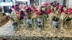 flowers are in mason jars on the counter