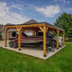 a car is parked in front of a boat on the driveway next to a house