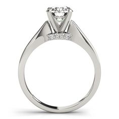 a white gold engagement ring with two stones on the side and a diamond set in the center