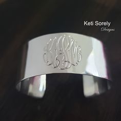 "Large cuff bracelet with etched monogram initials in the precious metal of your choice. Create personalized gift for your loved ones. Amazing jewelry for every day wear or special occasions. Designs by: Keti Sorely. Metal options: *Brass w/ yellow gold overlay *Brass w/ Rose gold overlay * Sterling Silver  * Sterling Silver with yellow gold overlay * Sterling Silver with Rose gold overlay Bangle width - 1\" Choose bangle sizes: Small (6-6.5\"),  Medium (7-7.5\")  Large (8-8.5\"). 1 to 3 letters Elegant Stamped Cuff Bracelet, Classic Personalized Initials Bracelet, Elegant Stamped Cuff Bracelet For Wedding, Engraved Cuff Bracelets For Anniversary, Classic Monogram Name Bracelet As Gift, Engraved Cuff Bracelet For Wedding, Elegant Monogram Name Bracelet As Personalized Gift, Elegant Silver Bracelets With Initials, Elegant Monogram Name Bracelet For Personalized Gift