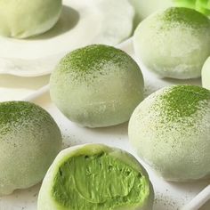 several green desserts with powdered sugar on them