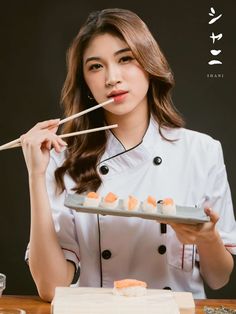 a woman holding chopsticks over a plate of sushi