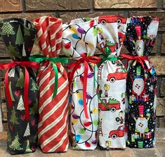 several christmas wrappings are tied together on a brick wall and placed next to each other