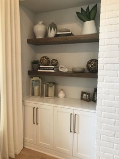 some shelves with vases and other items on them