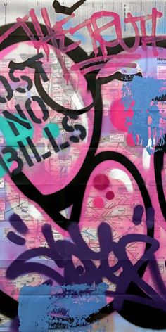 graffiti on the side of a wall with words written in pink, blue and purple