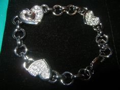 Stackable Heaven  DESCRIPTION:  ♦Swarovski Rhinstone silver plated Hearts Bracelet ♦Color: Silver Rhinestone ♦One size fits all   SHIPPING:  ♦Domestic: USPS First Mail: (2-5 business days with tracking number) ♦International: USPS First Class International Mail: (7-15 business days) ♦Other shipping methods available. please contact me through email for further information.  RETURNS:  ♦ Please email me prior to returning any item. ♦ Returns excepted 3 days after item is received. ♦ Buyer is responsible for return shipping cost.   Feedback is greatly appreciated. Your satisfaction is my first priority.  Thank you(: Silver Heart Bracelet With Diamond Accents, Silver Rhinestone Bracelets For Valentine's Day, Silver Heart Bracelet With Diamond Accents For Wedding, Silver Crystal Heart Bracelet For Wedding, Valentine's Day Silver Bracelets With Rhinestones, Valentine's Day Silver Bracelet With Rhinestones, Silver Heart Bracelets With Diamond Accents, Silver Metal Heart Bracelet For Wedding, Heart-shaped Rhinestone Bracelet As Gift