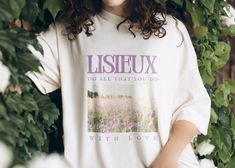 "\"Do all that you do with love.\" - Saint Therese Carry this beautiful reminder of love with you everywhere you go with this St. Therese of Lisieux graphic t-shirt 🌼 If you desire an oversized look, grab one of your favorite large shirts from home and take measurements of width and length, then referencing the size chart above (included in the pictures) compare your measurements to help choose which size will give you the look you desire.  Welcome to BELOVED! Here you will find cozy and comfortable crewneck sweatshirts, lovingly designed to be versatile and attractive. Whether you are cozying up in your favorite loungewear, or layering with outerwear, there are countless ways to wear your Beloved sweatshirts. + Material & Care + Our t-shirts are made from 100% ring-spun cotton Machine wa Catholic St Joesph Tshirts, Saint Shirt, Catholic Clothing, Catholic Shirt, Catholic Tshirts, Saint Therese, Saints Shirts, St Therese Of Lisieux, Thérèse Of Lisieux