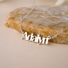 Discover the luxurious charm of the Malibu Name Necklace! Handcrafted with love and attention-to-detail, this gorgeous necklace is the perfect way to show off your name with style. Layer with your favorite necklaces for a boho glam look. NECKLACE FEATURES Choice of Finish: 18k gold plating over sterling silver or Sterling Silver handcrafted custom name pendant. Choice of Size: Small (approx. 3/4 inch) or Large (approx. 1.25 inches) Gold filled or sterling silver cable chain. All necklace finding Bohemian Sterling Silver Charm Necklaces For Gifts, Trendy Silver Necklaces With Charms, Trendy Silver Necklace With Charms, Personalized Adjustable Jewelry Gift For Her, Bohemian Personalized Necklaces For Everyday, Everyday Personalized Bohemian Necklaces, Everyday Bohemian Personalized Necklaces, Personalized Bohemian Charm Necklace With Pendant, Silver Nickel-free Nameplate Necklace