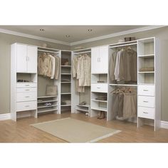 a white closet with lots of clothes and shoes on it's shelves in a room