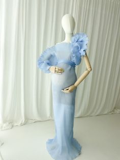 a mannequin dressed in a blue dress with ruffles