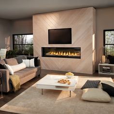 a living room filled with furniture and a flat screen tv mounted on the wall above a fire place