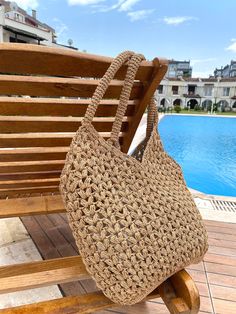 A beautiful and unique handmade bag available in two sizes.This stylish bag is made with high quality paper yarn.It can be used both daily or at the beach.It is also a great gift for any occasion. Product details: -It is crochet. -It is not lined and has not pockets. -Not washable,not dry clean.It can be wiped with a damp cloth. -Delivery time may vary between 20-25 days. -We make it according to the order. -Made in Türkiye. Material:Paper Yarn Dimensions:           Large 58x45 cm./22,83x17,71 inc.           Small 55x36 cm./21,65x14,17 inc. Color:Onion,Cherry,Chocolate,Kraft,Elektric Blue,Dark Green,Pearl,Wine,Yellow,Pink,Pistachio,Coral,Black,Mink,Turquoise Brown Braided Crochet Bag For Beach Season, Eco-friendly Open Weave Shoulder Bag For Beach, Brown Open Weave Crochet Bag For Vacation, Brown Braided Crochet Beach Bag, Brown Braided Crochet Bag For Beach, Brown Braided Beach Bag, Brown Crochet Bag With Open Weave For Vacation, Beachy Crochet Bag Made From Natural Fiber, Beachy Crochet Bag With Woven Natural Fiber