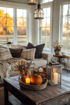 a living room filled with lots of furniture and candles on top of a wooden table