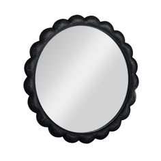 a round mirror with an ornate design on the front and back side, in black