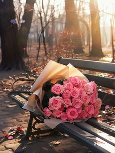 a bouquet of pink roses sits on a park bench