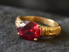 Gold Ruby Ring set with a created Ruby in a flawless diamond cut & clarity, deep red color (10x8mm, 3Ct). Made of Gold Vermeil ☞ thickest 18k Gold Plating on Solid 925 Sterling Silver ☞ made to last. Matching Pendant: www.etsy.com/listing/963627546 Matching Earrings - please ask me ☞ Choose your size ☞ I resize (before shipping) for FREE to Any size* *Sizes 13-16 U.S. need to be custom made & May include an additional cost, I will contact you before starting work on those custom-made sizes with Red Jewelry With Center Stone In Round Band, Red Jewelry With Center Stone Round Band, Red Jewelry With Accent Stones And Round Band, Red Round Band Promise Jewelry, Red Garnet Round Band Jewelry, Red Ruby Round Band Jewelry, Red Ruby Ring For Promise With Round Band, Red Ruby Promise Ring With Round Band, Red Ruby Birthstone Ring With Round Band