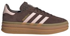 Design: Iconic Gazelle silhouette with bolder details Serrated 3-stripes and a metallic-gold "Gazelle" Classic lace closure with a premium soft suede upper Durability & Traction: Tripled-stacked platform rubber outsole adds elevated style and traction Additional Details: Runs big, size down 1/2 size Brown Gazelle Adidas Outfit, Brown And Pink Adidas, How To Style Gazelle Adidas, Platform Adidas Gazelle, Adidas Gazelle Brown, Tan Adidas Shoes, Brown Gazelle, Gazelle Bold Outfit, Popular Adidas Shoes