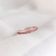 This stunning full eternity ring is set in 14k Solid Yellow Gold with Natural Pink Tourmaline with utmost precision. It is an unique dainty gemstone ring for nearly every occasion and is completely hassle-free jewelry. ITEM DETAILS * Gem: Pink Tourmaline * Gem Size: 2mm * Gem Shape: Round * Gem Weight: 1.00 carats * Gold Purity: 14KT * Gold Weight: 1.44 gram * Total Weight of the Ring: 1.64 gram The Gold purity is guaranteed and it comes with authentic 14KT gold hallmark. Since my items are handmade, they are absolutely nickel and lead free. CUSTOMIZATION * Gemstone customization is available, it can be substituted with a gem of your choice. It is available in gemstones such as Amethyst, Topaz, Onyx, Citrine, Garnet, Aquamarine and many more. Kindly drop me a message for  the same. PACKAGI Ruby Eternity Ring, October Birthstone Ring, Infinity Band, October Birthstone Rings, Handmade Jewelry Box, Pink Tourmaline Ring, Full Eternity Ring, Citrine Ring, Tourmaline Ring