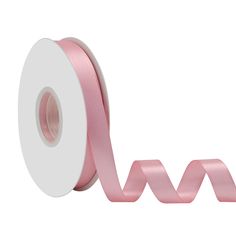 a roll of pink satin ribbon on a white background with an arrow in the center