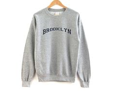 Brooklyn New York Unisex Pullover Crewneck. The perfect vintage sweatshirt for your favorite city. - Unisex Size - Printed on the Gilden 1800 Sweatshirt - Loose fit - 50% Cotton; 50% Polyester (fibre content may vary for different colors) - Processing usually takes 3-5 and shipping usually takes 3-5 days - Medium fabric (8.0 oz/yd² (271.25 g/m - Sewn in label - Runs true to size *Personal customization is available. Please don't hesitate to reach out to us to inquire about personalized designs. Ohio Sweatshirt, Michigan Sweatshirt, Sweat Vintage, Staten Island New York, California Sweatshirt, New York Sweatshirt, Sacramento California, Wife And Kids, Vintage Crewneck