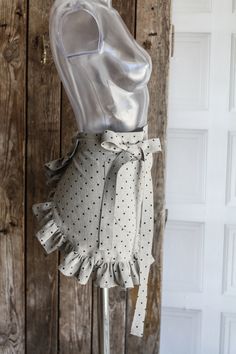 a mannequin wearing a silver top with polka dots