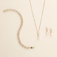 This sparkling rose gold necklace and earrings set will surely add brilliance to your special day! This gorgeous jewelry set is perfectly matched with marquise cubic zirconia stones and off white glass pearls. This stunning set is perfect for the bride or makes a great bridesmaid jewelry gift!   DETAILS * High quality cubic zirconia and 7mm off white glass pearls.  * Earrings measure 3/4 inch long (pierced or clip-ons). * Necklace is adjustable from 16 inches to 18 inches long, pendant (includin Gold Earrings And Necklace, Rose Gold Bridesmaid Jewelry, Pearl Wedding Jewelry Sets, Gold Bridesmaid Jewelry, Pearl Wedding Jewelry, Pearl Bridesmaid Jewelry, Rose Gold Bridesmaid, Sparkling Rose, Gold Pearl Jewelry