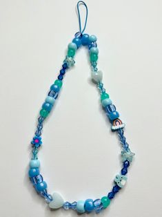 Handmade Multicolor Phone strap. 🧡 Materials: Crystals beads, Plastic Beads. 💕 9 inches long Casual Large Blue Beads, Adjustable Blue Beaded Necklace With Heart Beads, Casual Blue Beaded Necklaces With Large Beads, Casual Blue Beaded Necklace With Large Beads, Blue Beaded Necklaces With Letter Beads For Festivals, Blue Beaded Necklace With Letter Beads For Festival, Blue Beaded Necklaces With Heart Beads For Festivals, Trendy Blue Beaded Chain Bracelet, Trendy Blue Beaded Bracelet