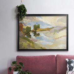 a painting hanging on the wall above a pink couch in a living room with potted plants